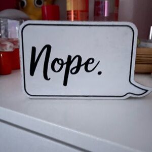 White and black nope word bubble